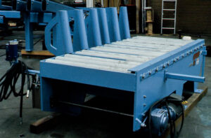 Blue industrial conveyor system with rollers and vertical guides.