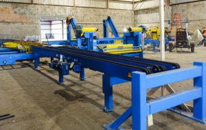 Blue and yellow industrial machinery setup in an empty factory space.